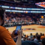 Arizona sports betting - a man betting on mobile at a Phoenix Suns game at the Footprint Center